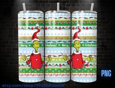 two christmas cans with the grin on them are next to a brick wall and there is a sign that says merry christmas