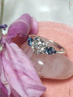 a close up of a ring on top of a flower