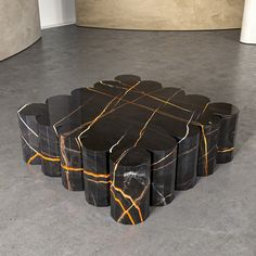 a black and gold table sitting on top of a cement floor