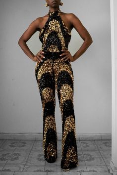 "Get glam in our Sequin Halter Flare Pants Jumpsuit. This piece has an all-over two-tone black & gold sequin swirl motif design. The fabric is stretchy to flatter your curves and has a hidden zipper for easy wearing. Perfect for your special events such as a birthday, wedding events, date nights, and much more.  Details Jumpsuit: Stretch  Shell Fabric Content: Nylon/Spandex Lining Content: Polyester/Spandex Care Instruction: Hand Wash or Dry clean Fit *True to size  *Inseam Length 37\" *Fitted/f Black Tie Jumpsuit, Romper Women, Pants Jumpsuit, Party Rompers, Disco Pants, Sequin Halter, Get Glam, Sequin Jumpsuit, Halter Jumpsuit