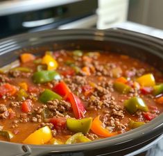 a crock pot filled with meat and vegetables