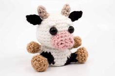 a crocheted stuffed cow with black and white stripes on it's face