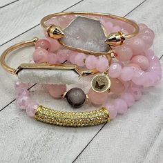 Meet our 'Pink Princess' bracelet stack – where glam meets a dash of royal sass for a coronation of fabulous flair! These bracelets aren't just accessories; they're your tiara in the world of wristwear, ready to make every day a regal runway. A Real Stunner - Reach for this beautiful stack when you want to stand out from the crowd. Wear them all on one wrist and stack 'em up or wear 3 on one wrist and 3 on the other your favorite watch! Lead & Nickel Free Bracelets are 'one size fits most' and are designed to fit wrists up to 7.5" comfortably Set of 6 Bracelets (4 Stretch, 1 Gold Arrow Cuff & 1 Gold Cuff with a White Druzy Stone Inlay) Pave Crystals Quartz Natural stone Pink Hues with little tiny hints of gray in some bead Please be aware that due to the unique and handmade nature of each Glamorous Adjustable Bracelet As Gift, Glamorous Adjustable Bangle Bracelets, Adjustable Pink Gold Bracelet For Party, Elegant Pink Stackable Stretch Bracelet, Pink Stackable Beaded Bracelets For Party, Elegant Pink Bangle Stretch Bracelet, Pink Jubilee Bracelet For Party, Trendy Pink Jubilee Bracelets, Pink Crystal Bangle For Party