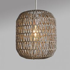 a light that is hanging from the ceiling with some kind of woven material on it