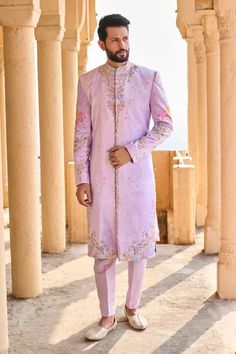 Lavender sherwani with floral print and bead embroidery. Paired with kurta and pant.
Component: 3
Pattern: Printed, Embroidery
Type Of Work: Floral, bead
Neckline: Mandarin collar
Sleeve Type: Full sleeves
Fabric: Velvet, Lining: Satin
Color: Purple
Other Details: 
Front pockets
Side slit
Occasion: Destination Wedding - Aza Fashions Embroidered Sherwani, Printed Embroidery, Hand Work Design, Indian Men, Indian Men Fashion, Beaded Neckline, Satin Color, Purple Velvet, Fashion App