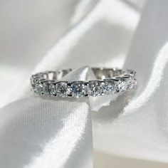 a wedding ring on top of a white cloth