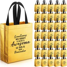 a gold bag with black handles is next to a pile of golden bags that say sometimes you forget the awesome someone so this is your reminder