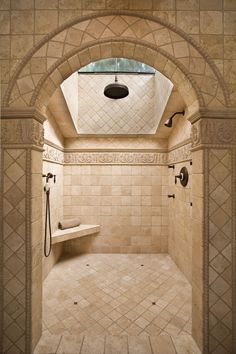 a bathroom with a skylight and tiled walls