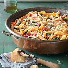 a pot filled with pasta and cheese on top of a table