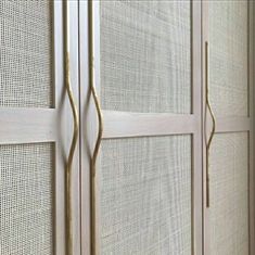 an image of a white closet with gold handles