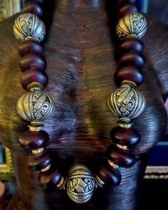 Rare and Scarce beads abound in this lightweight, 34" Moroccan Burgundy Resin and Tibetan Silver Fancy Repousse Tribal Statement Rope. Each bead is separated by a gold aurora borealis rhinestone rondelle. Iris Apfel Inspired. The back is finished with tribal silver tone stamped bi-cones, round black onyx, tribal spacers and ornate bi-cones. Fastens with a fancy hook and eye. Unisex styled. Great worn alone or as a layering piece. From KatKouture. Festive Bohemian Hand-strung Beaded Necklaces, Bohemian Hand-strung Necklaces For Festive Occasions, Bohemian Hand-strung Necklace For Festive Occasions, Festive Bohemian Hand-strung Necklaces, Festive Large Beaded Spiritual Necklaces, Festive Spiritual Beaded Necklaces With Large Beads, Festive Large Beads Spiritual Necklace, Festive Spiritual Large Beaded Necklaces, Festive Bohemian Hand-strung Necklace