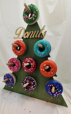 a wooden christmas tree with donuts on it