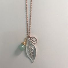 "Default is silver plated. Rose gold and Gold available upon request. These are the cutest initial necklaces around. Great for bridesmaids, birthdays, new mom or grandma gifts, or for yourself. Dainty and sophisticated. Price is for one initial and one stone with leaf charm. Necklace comes in a glass bottle ready to give as a gift. Please message me with custom requests for additional stones or letters. 10% discount available when you purchase 4 or more necklaces. Letters and chain are gold or s Tiny Initial Pendant Charm Necklace For Gifts, Personalized Green Initial Pendant Necklace, Elegant Gold-tone Charm Necklace With Initial Pendant, Gold-tone Initial Pendant Chain Necklace For Gift, Gold-tone Initial Pendant Charm Necklace With Adjustable Chain, Custom Initial Necklace, Custom Bottles, Custom Initials, Leaf Charms