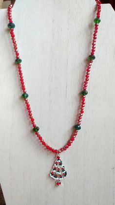 This necklace is made with red rondelles, green rondelles, and a Christmas tree charm in the middle. Toggle clasp. Measures 19 inches long end to end. Red Faceted Beads Jewelry For Christmas, Red Christmas Necklaces For Jewelry Making, Handmade Green Holiday Necklaces, Handmade Green Necklace For Holiday, Handmade Green Necklace For Holidays, Red Round Bead Necklaces For Christmas, Adjustable Beaded Necklace For Christmas, Adjustable Round Beads Necklaces For Christmas, Christmas Necklace Ideas