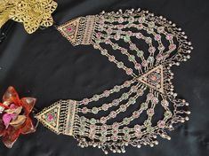 * This heavily embellished, seven-layer necklace is an epitome of tradition. Each string of the piece has multicolour stones embedded within the tiny floral motifs, complimenting the tribal style of the ornament. This astonishing piece is handcrafted by the local artisans of south Asia, who have kept such style of ornaments alive in the fashion. You can Pair this astonishing piece with any traditional attire to complement your look or add a pinch of ethnic touch to your trendy outfit. Note: The Oversized Necklace, Boho Cuff Bracelet, Hand Cuff Bracelet, Kuchi Jewelry, Boho Cuff, Afghan Jewelry, Headpiece Jewelry, Bracelets Set, Layer Necklace