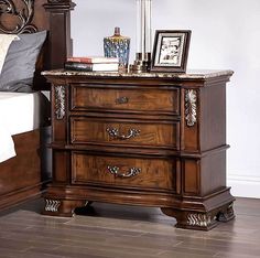 a bedroom scene with focus on the nightstand and bed side table in the foreground