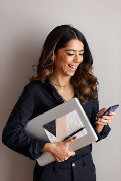 a woman holding a tablet computer and cell phone