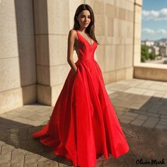 a woman in a red dress posing for a photo