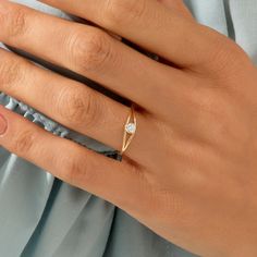 a woman's hand with a diamond ring on it