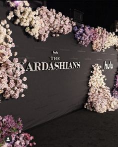 the wall is covered with flowers and words that spell out the name of the kardashians