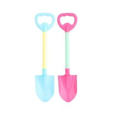 two pink and blue shovels sitting next to each other