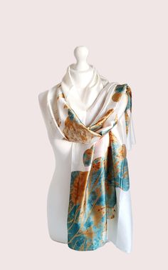 The Water Lily print Scarf is a luxurious and elegant accessory made from silk feeling premium polyester This beautiful scarf adds a touch of artistic flair to any outfit. Its soft and lightweight texture makes it perfect for draping around the shoulders or tying as a headscarf. This gift for her can be complemented with an optional gift box and card. Whether for a special occasion or everyday wear, this beautiful Scarf is a timeless and stylish addition to any woman's wardrobe. Perfect gift for her and your loved ones! Size: 90 x 180cm Transitional Style Perfect for all seasons Water Lily Design Art Print Scarf Luxury Scarf Care instructions : Cold wash only.  Do not bleach Do not tumble dry Iron in low temperature Elegant White Rectangular Scarves, Elegant Rectangular Silk Scarf For Gifts, Elegant Rectangular Silk Scarf For Gift, Elegant Rectangular Silk Scarf As Gift, Elegant Rectangular Silk Scarf Gift, Elegant Cream Silk Scarf As A Gift, Elegant Cream Silk Scarf For Gift, Elegant Cream Silk Scarf As Gift, Elegant Multicolor Silk Scarf For Wedding