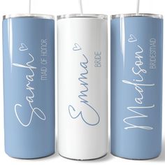 three blue and white personalized tumblers with straws in each one's mouth