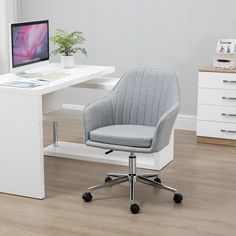 a chair that is sitting in front of a desk with a computer on top of it