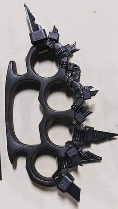 a pair of scissors with spikes attached to them