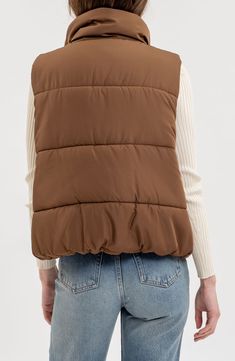 Whether you're deep in the backcountry or just your own backyard, you'll appreciate the cozy core warmth of this vest filled with polyester insulation. 24" length Front zip closure Stand collar Front welt pockets Lined, with 100% polyester fill 100% polyester Machine wash, line dry Made in China Brown Puffer Vest Women, Puffy Vest Brown, Brown Northface Vest, Brown Puffer Gilet, Cozy Core, Womens Tailored Suit, Quilted Puffer Vest, Flannel Tops, Graphic Tops