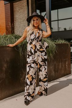 - Kick back and enjoy some vacay vibes in this stylish jumpsuit! - Unlined material with an abstract floral print - A v-cut neckline with a twist detail - Adjustable spaghetti straps - A smocked upper back with a tie detail - A wide legged jumpsuit with floor length hemlines Chic Printed Jumpsuits And Rompers For Vacation, Chic Printed Jumpsuit For Vacation, Chic Floral Print Jumpsuits And Rompers For Beach, Chic Floral Print Beach Jumpsuit, Chic Beach Jumpsuit With Floral Print, Chic Black Printed Jumpsuits And Rompers, Black Printed Jumpsuits And Rompers For Beach, Black Printed Jumpsuit For Beach, Black Floral Print Jumpsuits And Rompers For Vacation