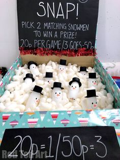 a box filled with marshmallow snowmen and a sign that says snap pick 2 matching snowmen to win a prize