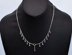 "This amethyst 925 silver princess bib from the 70's is a dainty sterling & purple bead dangles figaro chain necklace.  It measures 17 1/4\" (43.815 cm) end to end. The bib is 5 1/8\" (13.0175 cm) wide, by 3/16\" (0.47625 cm) long. Total weight is 6.6 grams. It is in excellent vintage condition. It has an ethereal airy design and is nicely made. This charming vintage bib necklace is fit for a princess." Elegant Dangle Charm Necklaces With Lobster Clasp, Elegant Dangle Charm Necklace With Lobster Clasp, Sterling Silver Dangle Necklaces In Costume Jewelry Style, Sterling Silver Dangle Costume Jewelry Necklaces, Sterling Silver Dangle Necklaces Costume Jewelry, Silver Dangle Charm Necklaces With Gemstone, Silver Dangle Charm Necklace With Gemstone, Silver Gemstone Dangle Charm Necklaces, Delicate Sterling Silver Drop Necklaces