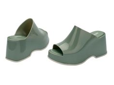 Throwback style meets current trends—that’s just how the Patty rolls. Lightweight and streamlined with a wide strap and a peep toe, these platform mules are true attention seekers, and the contrasting sole detail amps up the cool factor. Made from our revolutionary Melflex® PVC plastic, you enjoy more flexibility and comfort. Plus, they’re 100% recyclable. Trendy Platform Slip-on Slides, Modern Platform Slip-on Slides, Green Casual Synthetic Platform Slippers, Casual Green Synthetic Platform Slippers, Trendy Platform Mules, Green Open Toe Casual Platform Slippers, Casual Spring Platform Slippers, Casual Green Platform Slippers For Summer, Casual Green Open Toe Platform Slippers