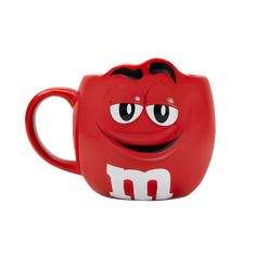 a red mug with a smiley face on it