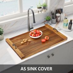 a wooden cutting board sitting on top of a kitchen counter next to a bowl of tomatoes