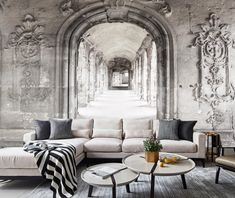 a living room filled with furniture and walls painted in black and white colors, along with an arched doorway