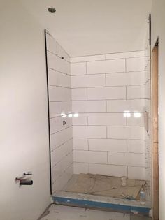 the shower is being installed in the corner of the room, and it's not too far from the wall