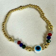 Evil Eye Elastic Bracelet With Colorful Crystal And Gold Filled Balls Brand New Adult Size Center Evil Eye Gold Filled Balls On Each Side Of Evil Eye Casual Gold Beaded Bracelets For Party, Multicolor Beaded Bracelet With Evil Eye, Casual Gold Stretch Bracelet With Colorful Beads, Casual Gold Bracelets With Colorful Beads, Trendy Gold Crystal Bracelet With Colorful Beads, Rainbow Casual Jewelry For Party, Casual Rainbow Jewelry For Party, Casual Handmade Gold Crystal Bracelet, Boho Bangle Bracelets