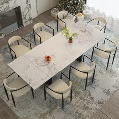 a dining room table with chairs and a potted plant on it in front of a christmas tree