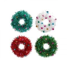 three christmas wreaths with different colors and designs on them, one is green, the other is red