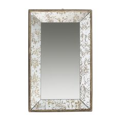 a white and gold framed mirror with an ornate design on the front, against a white background