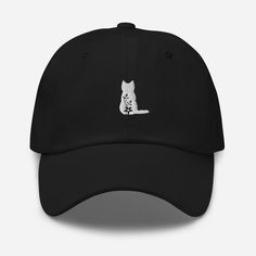 "Embroidered Black Floral Cat Hat | Cat Mom Hat | Floral Cat Dad Hat | Pet Owner Gift | Cat Mother Gift Idea | Cute Cat Cap ** HOW TO ORDER 1. Check our photos for sizing and color options.  2. Select your size and color from the drop-down menus.  3. Click \"ADD TO CART\" to add the shirt to your cart. 4. Click \"PROCEED TO CHECKOUT\" to purchase your shirt. ** SIZE One size fit all with adjustable strap with antique buckle ** DETAILS: - 100% chino cotton twill - Green Camo color is 35% chino cotton twill, 65% polyester - Unstructured, 6-panel, low-profile - 6 embroidered eyelets - 3 ⅛\" (7.6 cm) crown - Adjustable strap with antique buckle ** CARE: - Machine wash: cold water - Air dry ** PRINTING METHOD: Embroidered printing is a captivating process that combines embroidery and printing t Black Cat Ears Hat With Cat Design, Black Cat Design Hat With Cat Ears, Black Hat With Cat Ears And Cat Design, Adjustable Black Hat With Cat Design, Mom Hat, Mom Hats, Floral Cat, Cat Hat, Camo Colors