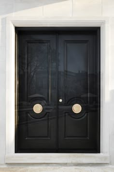 a black double door with two round knobs on the front and side doors are shown