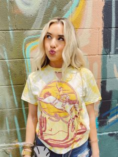 GINA Desert Cowboy mustard tie dye tee with key hole neck cut out! Saddle up cowgirl let's ride into the wild this summer in this cute new tee! Love the tie dye trend! This is a summer must have! Unisex style tee, model wearing size small! Desert Cowboy, Country Festival Outfit, Womens Western Fashion, Black Fringe Dress, Fashion Butterfly, Christmas Dress Women, Long Sleeve Denim Jacket, Rodeo Outfits, Formal Dresses With Sleeves