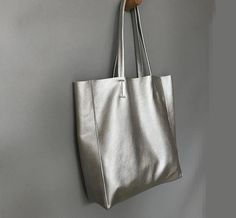 Overview: Design: Fashion Womens Silver Leather Oversize Tote Bag Silver Shoulder Tote Bag Silver Handbag Tote For WomenIn Stock: Made to order (2-3 days)Include: Tote + A detachable Side InnerCustom: NoColor: SilverLeather: CowhideMeasures: Horizontal Style S: 46cm/Bottom 34cm x 30cm x 14cmHorizontal Style L: 50cm/Bottom 37cm x 33cm x 16cm Vertical Style S: 41cm/Bottom 33cm x 35cm x 11cm Vertical Style L: 47cm/Bottom 37cm x 40cm x 11cmWeight: 0.75 kgSlots: 1 slotAccessories(option): NoStyle: Fa Silver Leather Tote Bag, Silver Textured Leather Tote Shoulder Bag, Elegant Tote Bag With Silver-tone Hardware, Versatile Tote Shoulder Bag With Silver-tone Hardware, High-end Tote Bag With Silver-tone Hardware, Silver Handbag, Oversized Tote Bag, Oversized Tote, Needle Felting Tutorials