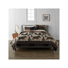 a bed in a room with white walls and wooden floors, along with an animal print comforter