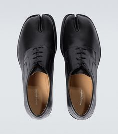 Find MAISON MARGIELA Tabi Leather Derby Shoes on Editorialist. Lining: leather. Sole: leather insole and sole. Toe shape: square toe. Upper: calf leather. Comes with a box, Comes with dust bag. Closure: lace-up. Made in Italy. Black Leather Shoes With Square Toe And Leather Sole, Black Leather Shoes With Square Toe, Pointed Toe Calf Leather Oxfords With Stitched Sole, Formal Leather Shoes With Pointed Toe And Vibram Sole, Formal Leather Oxfords With Square Toe, Business Calf Leather Shoes With Vibram Sole, Designer Leather Shoes With Pointed Toe And Leather Sole, Modern Leather Oxfords With Vibram Sole, Leather Oxfords With Almond Toe And Vibram Sole