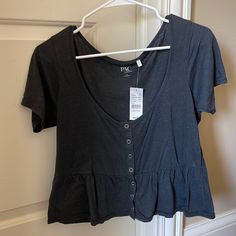 This Shirt Is Brand New And Has Never Been Worn With The Tags On It. It Is A Pretty Dark Gray Color With Buttons That Actually Work! Short Sleeve Tops With Buttons For Summer, Spring Short Sleeve T-shirt With Buttons, Spring Short Sleeve Button T-shirt, Spring Short Sleeve Buttoned T-shirt, Casual Button T-shirt For Spring, Summer T-shirt With Button Closure, Trendy Summer T-shirt With Button Closure, Trendy Short Sleeve Buttoned Tops, Trendy Short Sleeve Tops With Buttons