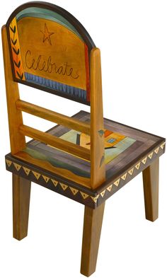 a child's wooden chair that has been painted with the word celebrate on it